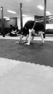 Two people grappling on the mats